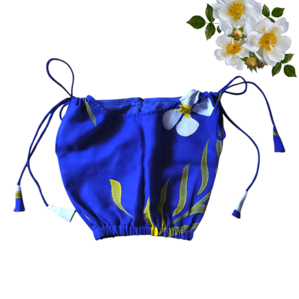 “Girls’ blue co-ord set with hand-painted white and yellow floral print – sleeveless top and flared shorts”